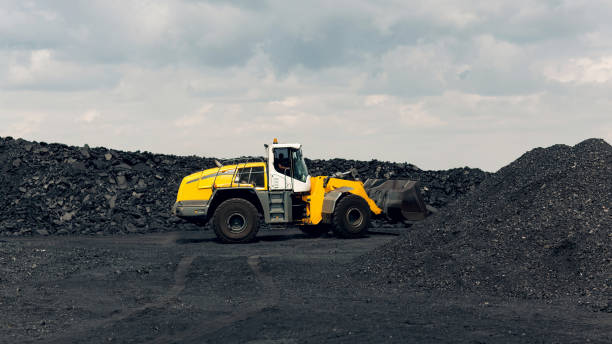 istock Yellow bucket loader is working busy loading coal. Extraction of minerals. 1418761865