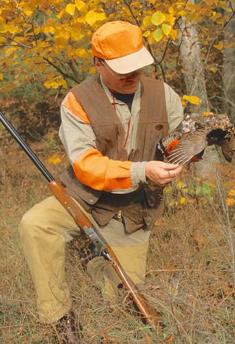 A hunter with a ruffed grouse