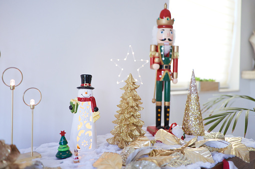 Two wooden Christmas Nutcrackers standing side by side. One  nutcracker is a drummer.  One figurine has black hair, and the other figurine has white hair.  Nutcrackers are used to crack open nuts, but can also be used as colorful Christmas decorations. The image is isolated on a white background.