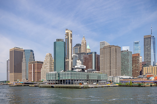Manhattan, New York, NY, USA - July 9th 2022: The Staten Island ferry terminal on the south end of Manhattan seen from a boat on East River
