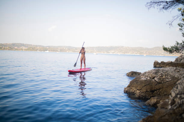istock woman stand up paddleboarding 1418766513