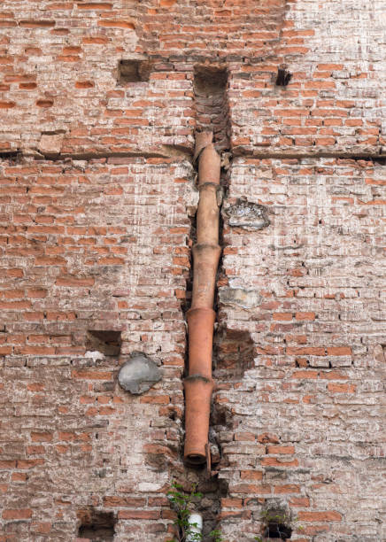 istock Old external drainage ceramic pipes on house 1418767741