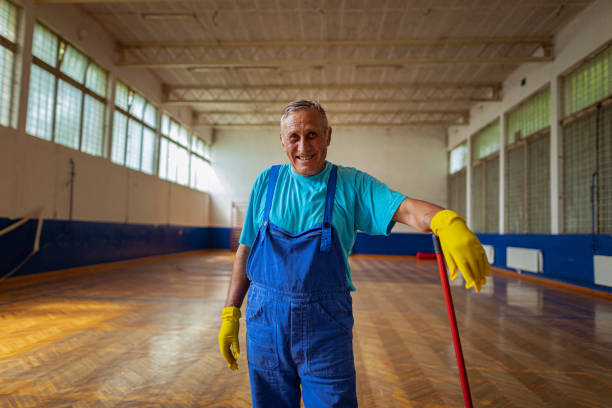 A portrait of a janitorial service member working at a school stock photo
