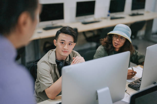 istock Asian adult student paying attention attending lecturer class listening and learning in computer lab 1418770848