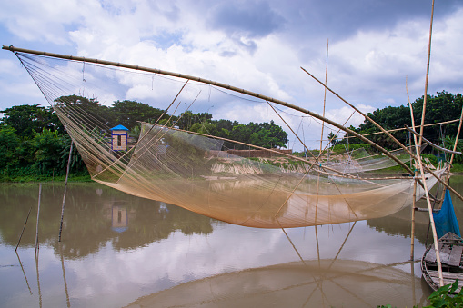 Traditional Fishing net Vessel \n in the river water by Bangladesh