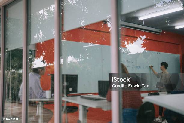 Looking Through Window College Student Giving Answers On Whiteboard In Classroom Showing Answer To Classmate And Lecturer Stock Photo - Download Image Now