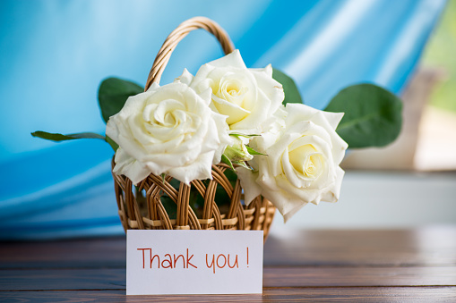 bouquet of beautiful white roses on a wooden table