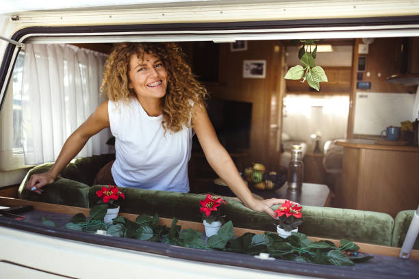 istock Happy woman in her camper trailer 1418772593