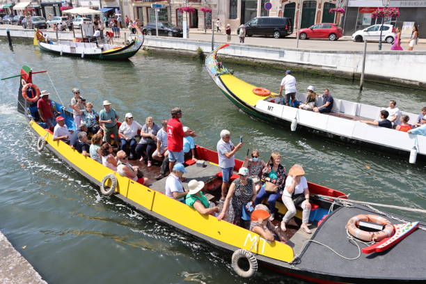 Aveiro - Portugal - July 17, 2022.Tourists aboard Aveiro traditional boats.