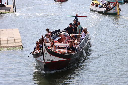 Aveiro - Portugal - July 17, 2022.
Tourists aboard Aveiro traditional boats.