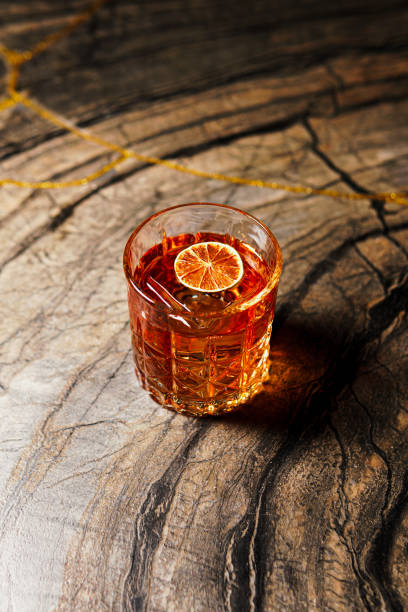 istock Alcoholic drink. A cocktail with whiskey or cognac on the table, close-up, dark background. 1418778383