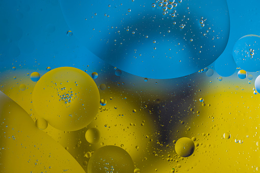 Close up view of beautiful water with yellow, black and blue abstract design texture.