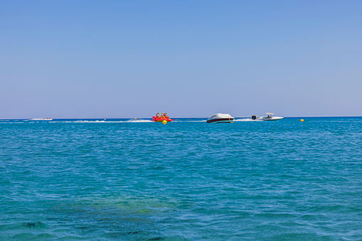 Rhodes. Greece. 07.25.2022 Beautiful view of sea activities for tourists. Blue sea water surface and blue sky background.