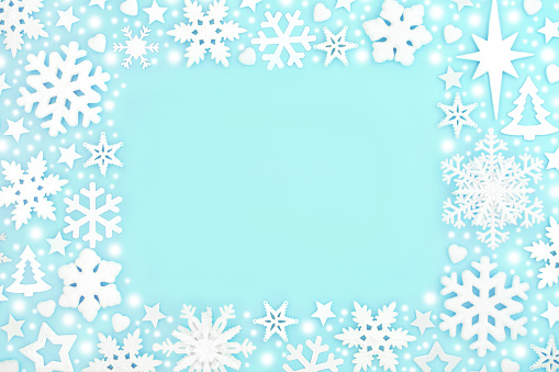 Christmas snowflake magical north pole background design with star and heart shape decorations on pastel turquoise. Fantasy symbols for winter, Xmas and New Year holiday Season.