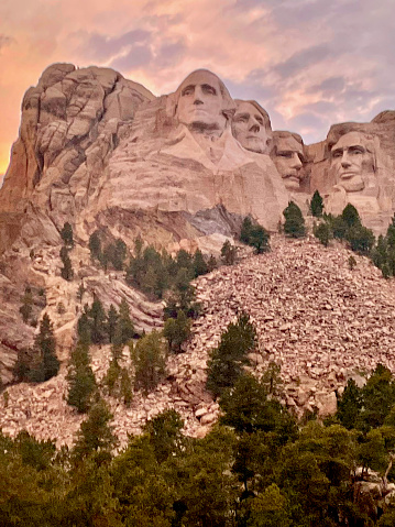 Keystone, South Dakota, USA - July 5, 2022: The sun sets behind Mount Rushmore on a warm summer evening at Mount Rushmore National Park.