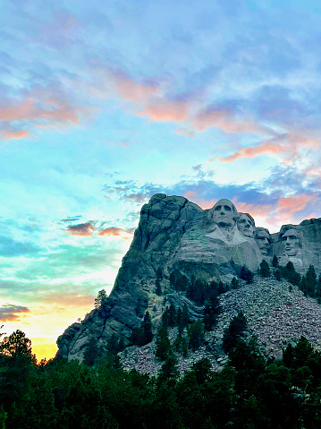 Keystone, South Dakota, USA - July 5, 2022: The sun sets behind Mount Rushmore on a warm summer evening at Mount Rushmore National Park.