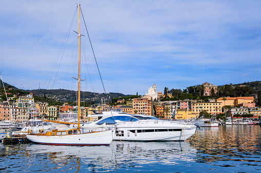 Ancient pastel-colored buildings are lined up along the marina of Santa Margherita Ligure