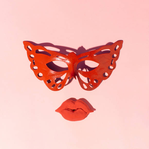 Carnival mask and full lips minimal creative layout. Red vintage carnival mask and full lips on pastel pink background. Minimalistic face. fish lips stock pictures, royalty-free photos & images