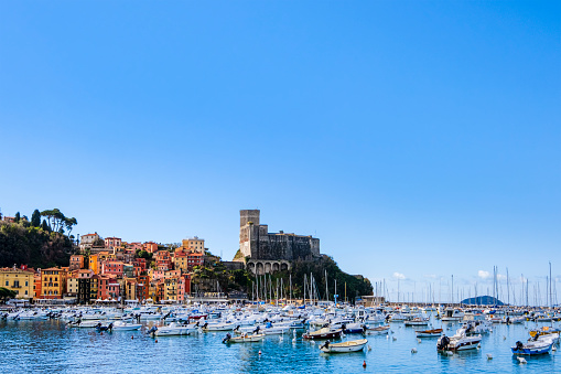 Marina of Lerici with in background the pastel colored buildings and the castle of the historic district