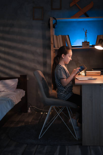 istock Schoolgirl doing her homework with digital tablet at home in the evening. Child using gadgets to study. Children, education and distance learning 1418792582