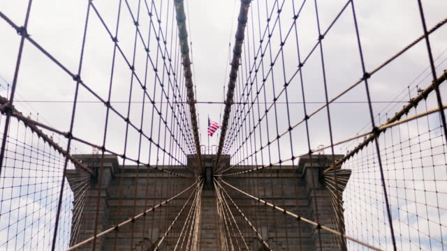 Perspective View of Brooklyn Bridge Towers with American National Flag on Top