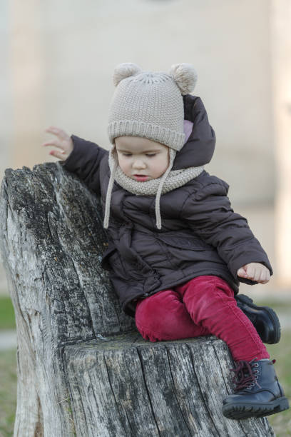 istock Child sit and playing on the tree stump 1418796769