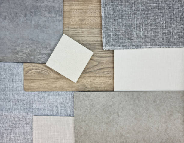 istock close up view of interior material samples including quartz stone, concrete vinyl flooring, grey drapery fabric, white fabric laminated, oak wooden vinyl flooring. mood and tone board. 1418797829