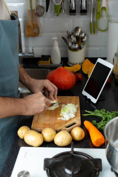 istock A Man Cooks Food, Cuts Onions 1418800572