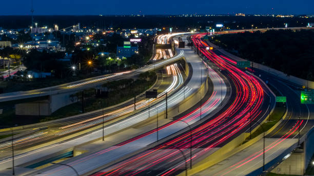istock Night traffic on a highway junction, with blurred motion and light trails. 1418807987