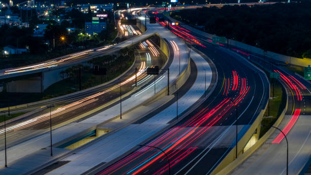 istock Night traffic on a highway junction, with blurred motion and light trails. 1418807989
