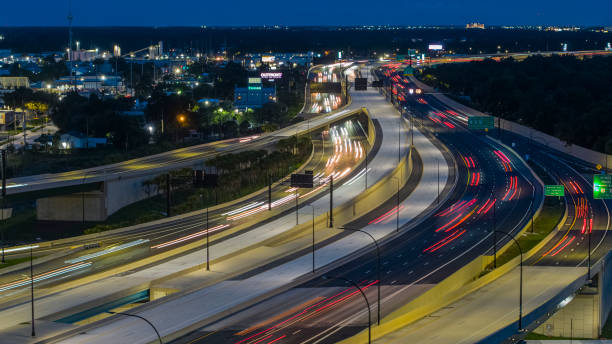 istock Night traffic on a highway junction, with blurred motion and light trails. 1418807992