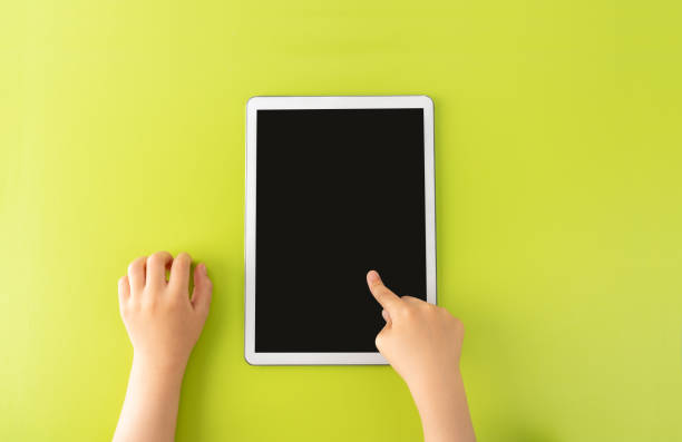 istock High angle shot of a little kid using a digital tablet 1418809427