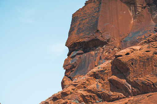 This huge red rock in Valley of Fire have the shape of an angry human face. Seen in Nevada, USA, a hot summer day.