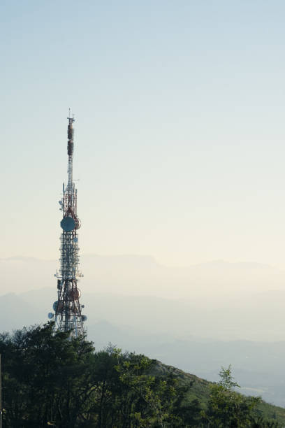 telecommunications tower with antennas for wireless communications with large spaces in the background