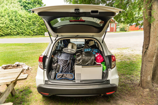 Travel on car with camping luggage packed at the full car trunk, holiday concept. Outdoor activities items. Camping and exploring in summer season. Adventures and travel suv vehicle. stock photo