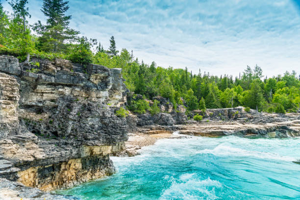 Indian Head Cove at Tobermory, turquoise blue water and green pine forest in Ontario Canada. Summer day at Bruce Peninsula National Park near Bruce trail, Georgian Bay Trail and Cyprus lake. stock photo