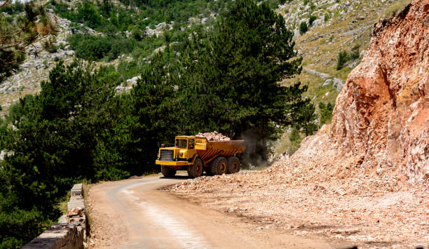istock Dump truck laden with stone on a mountain road 1418823340