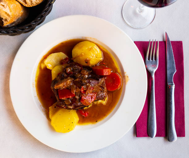 istock Appetizing lamb shoulder baked with potatoes and stewed vegetables 1418823436