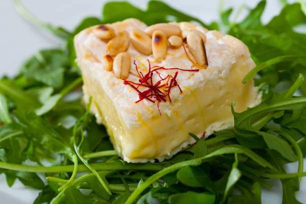 istock Camembert cheese with pine nuts and arugula 1418823561