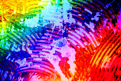 The pattern which was left behind after the removal of ceramic tiles from a wall, with saturated colours and rainbow effect.