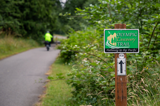 Sequim, WA USA - 07-18-2022: Olympic Discovery Trail with bicycle rider in soft focus in distance