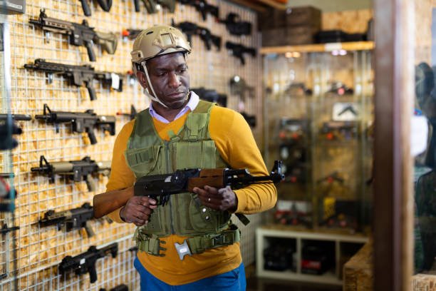 istock Man in armor choosing weapon in arms shop 1418827777