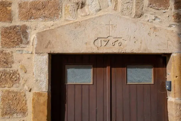Stone lintel of a stone building with 1760 engraved on it. Located in the Southern France village of Alet-les-bains