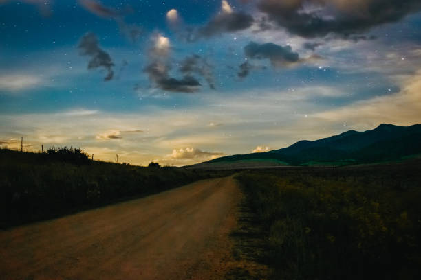 istock A country road at night under a starry sky 1418830464