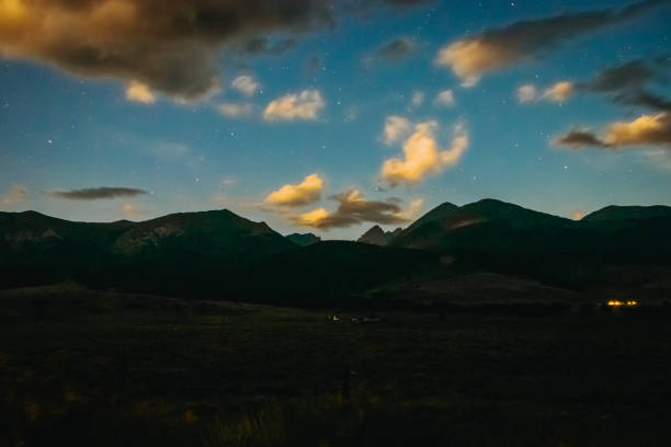 istock Mountain range at night with stars and clouds 1418830626