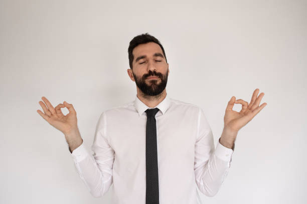 istock Caucasian man with beard meditating in studio 1418832488