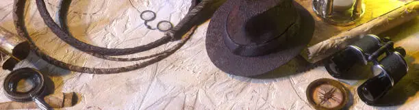 Photo of Travel concept around the world, compass, Indiana Jones style hat 3D 
render