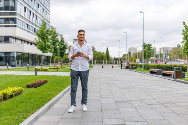 istock Businessman cheerfully holding his phone 1418839778