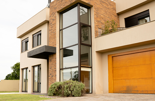 Stylish exterior of a contemporary two-story home with modern architectural features on an overcast day