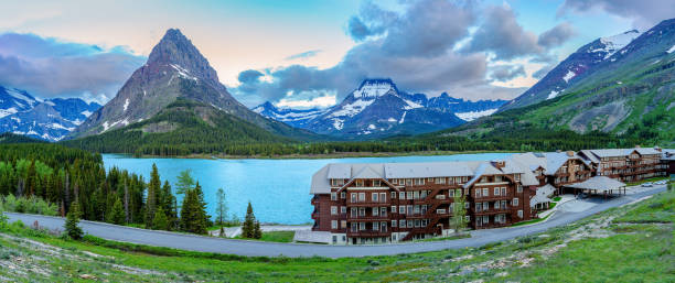 Many Glacier, Montana, USA –June 22, 2022: High mountain lake with hotel on the shore in Montana